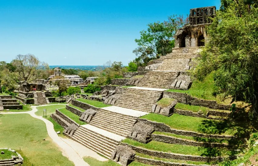 a stone steps on a hill with Palenque in the background